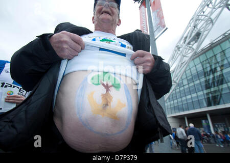 Wembley, London, UK. 11th May 2013.  A Wigan supporter shows off the crest of  the  Wigan Athletic team drawn on his belly as thousands of fans from greater Manchester descend on Wembley stadium for the FA Cup final between Manchester City and Wigan Athletic Credit: amer ghazzal/Alamy Live News Stock Photo