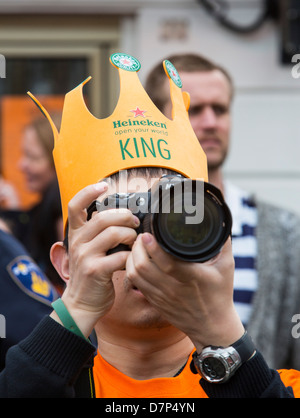 People celebrating annual Queens day in the old town of Amsterdam. Stock Photo
