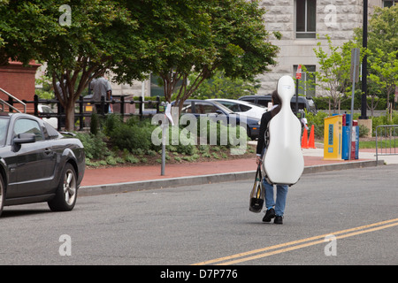 Classic double bass player crossing street Stock Photo