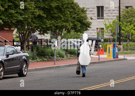 Classic double bass player crossing street Stock Photo