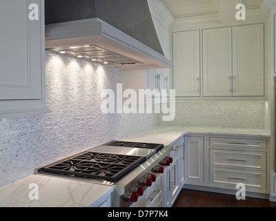 an empty kitchen with white cabinets and wood counter tops on the floor ...