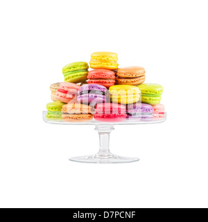 traditional french colorful macarons in a glass cake stand on white background Stock Photo
