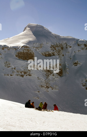 Picnic in the snow skiers eating lunch beneath the summit of Cornebois Portes du Soleil near Avoriaz Haute Savoie France Stock Photo