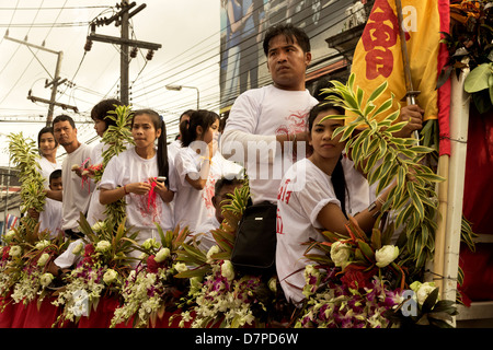 PHUKET, THAILAND OCTOBER 1 2011: Participants in ceremonial white ride a float during the annual Phuket Vegetarian Festival. Stock Photo