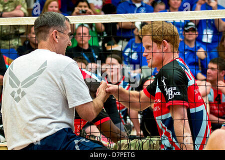 Prince Harry of Wales shakes hands with Lieutenant General John E. Hyten, Vice Commander of Air Force Space Command, during an exhibition volleyball match between U.S. and U.K. wounded warrior volleyball teams during the Warrior Games here May 11, 2013. Olympic gold medalists Misty May-Treanor, Missy Franklin and Paralympic medalists Kari Miller and Brad Snyder were in attendance to support the wounded athletes. From May 11-16, more than 200 wounded, ill and injured service members and veterans from the U.S. Marines, Army, Air Force and Navy, as well as a team representing U.S. Special Operati Stock Photo