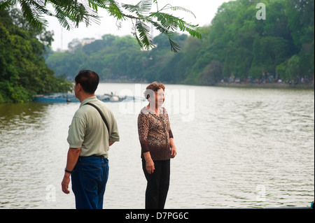 Hanoi, Vietnam - Senior couple standing by the lake Stock Photo