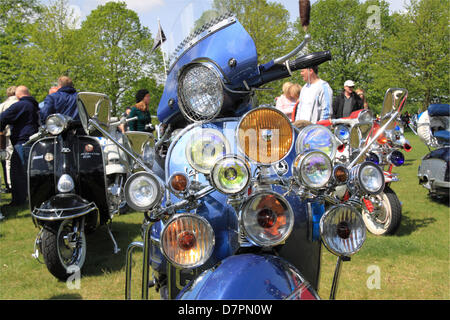 Vespa and Lambretta scooters at Chestnut Sunday. Bushy Park, Hampton Court, London, UK. Sunday 12th May 2013. Vintage and classic vehicle parade and display with fairground attractions and military re-enactments. Credit: Ian Bottle/ Alamy Live News Stock Photo