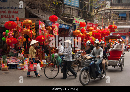 Horizontal streetscape of Chinese paper lanterns hanging outside a shop in the Old Quarter in preparation for Tet. Stock Photo