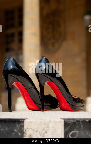 Pair of Christian Louboutin high heels in the courtyard of Palais Royal, Paris, France Stock Photo