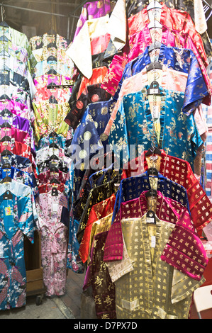 dh Temple street market JORDAN HONG KONG Chinese silk dressing gowns on display night market stall china gown garment Stock Photo