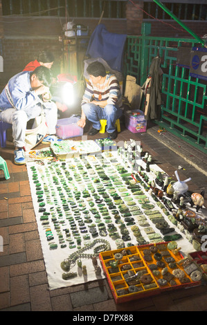 dh Temple street market JORDAN HONG KONG Chinese selling green jade pavement stall Hong Kong night market vendor asian outside asia Stock Photo