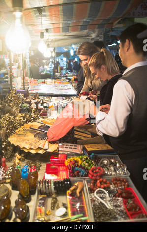 dh Temple street market JORDAN HONG KONG Girls shopping night market stall Hong Kong woman tourists people Stock Photo