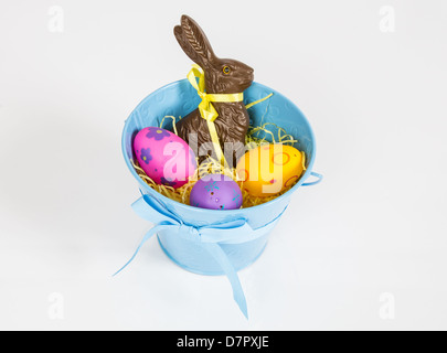 Easter Pail filled with toys, eggs, and candy. Isolated on a white background. Stock Photo