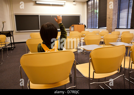 Boy sitting in class alone - USA Stock Photo