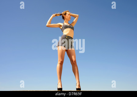 woman thinking , pulling her ponytail Stock Photo