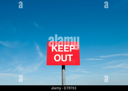 red keep out sign with blue sky Stock Photo