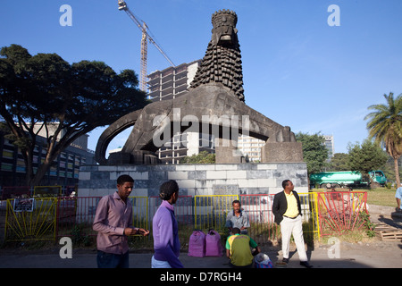 A man sits beneath a Lion of Judah statue outside the National Theatre, Addis Ababa, Ethiopia. Stock Photo