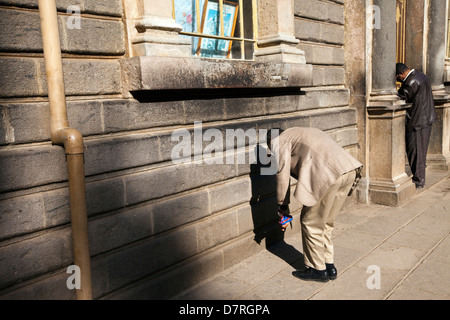 Men worshipping outside St George's Cathedral in Addis Ababa, Ethiopia Stock Photo