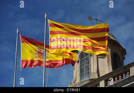 A Spanish (L) and a Catalan flag fly side by side on the roof of a building in Barcelona, Spain, 01 May 2013. Photo: Andreas Gebert Stock Photo