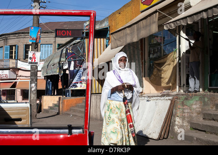 A traditionally dressed woman walking through the Piazza district in Addis Ababa, Ethiopia Stock Photo