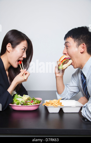 Two young business people eating a meal Stock Photo