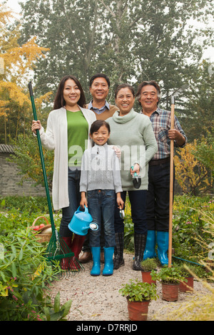 Happy family working in garden Stock Photo