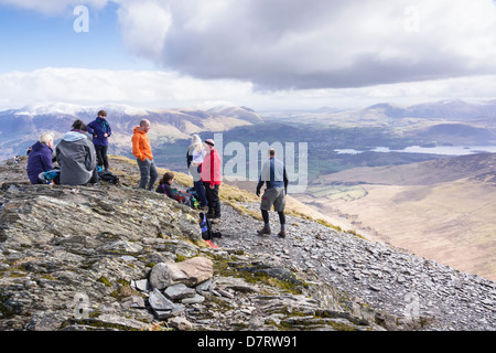 A group of hikers resting on the summit of Grisedale Pike in the Lake District