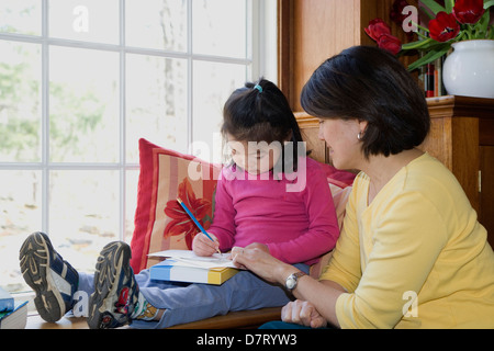 young student working at home with parent Stock Photo