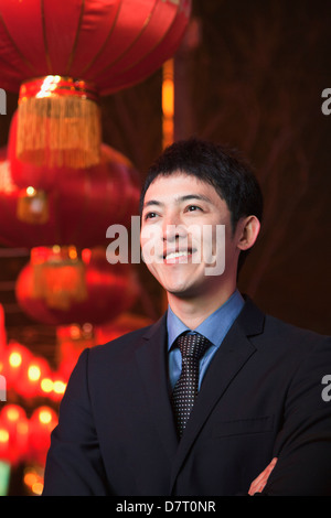 Businessman standing on the street, red lanterns on the background Stock Photo