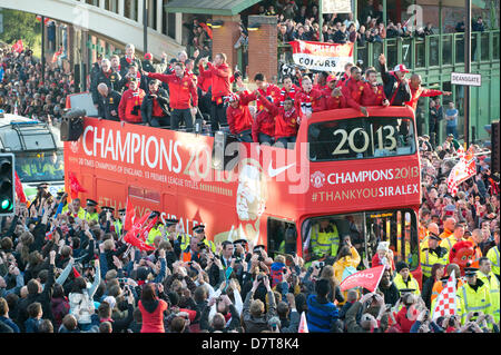 MANCHESTER, UK. 13th May 2013. Manchester United supporters flock to celebrate with their team the success of becoming the 2012/2013 English Barclays Premier League champions. Thousands of fans line the streets of the Manchester to greet their heroes. Credit: News Shots North/Alamy Live News (Editorial use only). Stock Photo