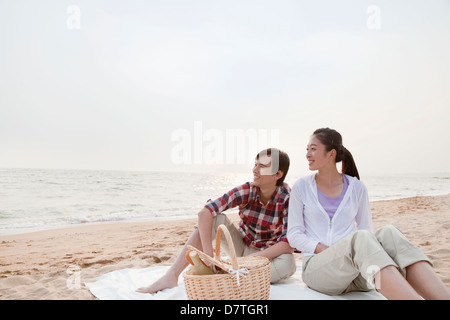 Couple Having a Romantic Picnic on the Beach Stock Photo