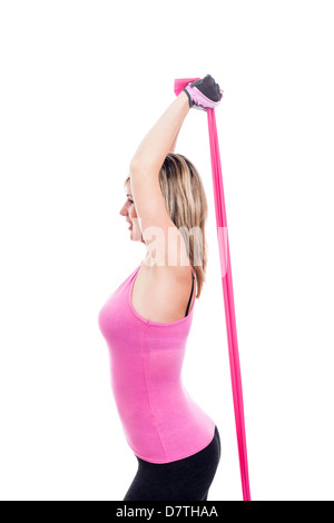 Young sportswoman stretching rubber band, isolated on white background. Stock Photo