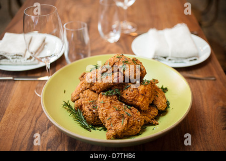 golden fried chicken, hot golden fried chicken, fried chicken in fry basket, frying chicken, seasoned fried chicken Stock Photo