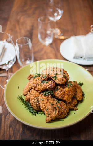 golden fried chicken, hot golden fried chicken, fried chicken in fry basket, frying chicken, seasoned fried chicken Stock Photo