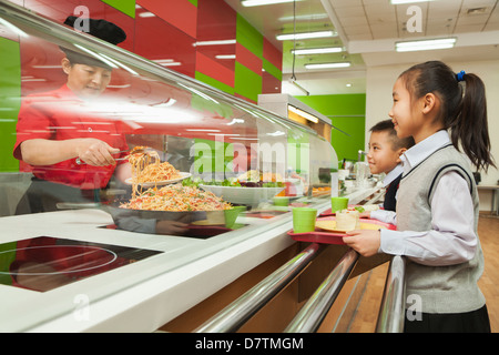 School children standing in line in school cafeteria Stock Photo