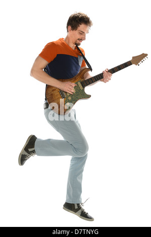 Musician playing electric guitar and jumping isolated over white background Stock Photo