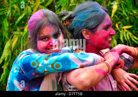 Two woman playing Holi festival in India Stock Photo