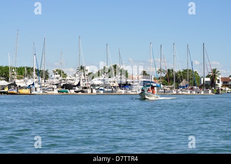 Motorboat with people leaving harbor in Puerto Vallarta, Mexico Stock Photo