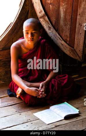 Novice Buddhist monk in lesson at Shwe Yaunghwe Kyaung, a famous teak monastery, Nyaungshwe, Inle Lake, Shan State, Burma,Asia