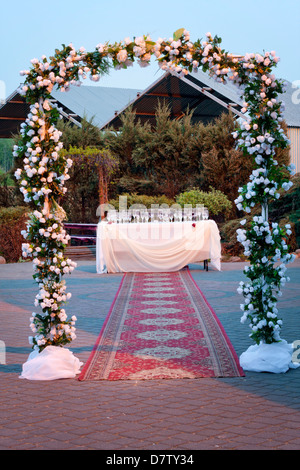 Wedding table outside with empty glasses of champagne after party Stock Photo