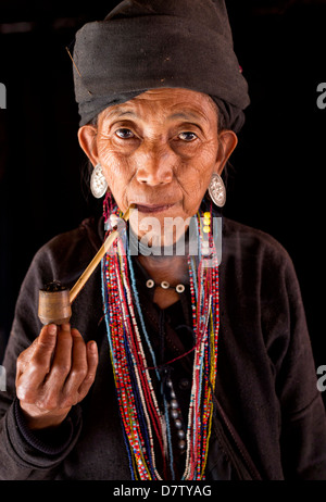 Woman of the Ann tribe in the doorway of her home in a hill village near Kengtung, Shan State, Burma Stock Photo