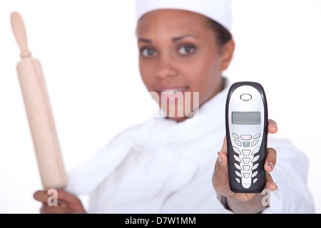 Chef holding up a telephone Stock Photo