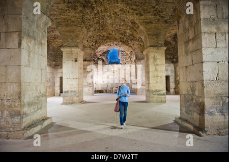 Tourist exploring the underground halls at Diocletian's Palace, UNESCO World Heritage Site, Split, Dalmatian Coast, Croatia Stock Photo