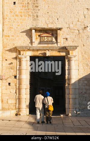 Tourist entering Old Town of Trogir through the South Town Gate, Trogir, UNESCO World Heritage Site, Dalmatian Coast, Croatia Stock Photo