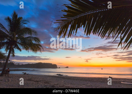 Sunset by the southern headland of beautiful Playa Pelada beach, Nosara, Nicoya Peninsula, Guanacaste Province, Costa Rica Stock Photo