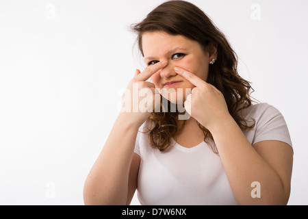 A young brunette teenage Caucasian girl checking her face and complexion skin Stock Photo
