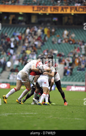 James Rodwell (Forward, England) holding onto the ball as players from Kenya attempt to get it off him during the 3rd place playoff of the HSBC Sevens World Series rugby competition at Twickenham Stadium, London. England beat Kenya by 26-19. Stock Photo