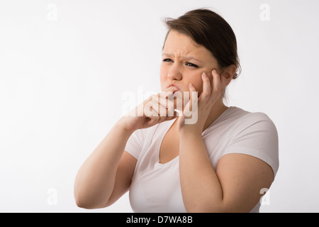 A young brunette teenage Caucasian girl suffering mouth pain toothache sore gums Stock Photo