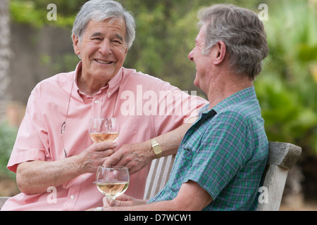 Two elderly men having a chat in the garden Stock Photo