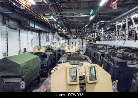 The Vehicle Deck onboard Assault Ship HMS Bulwark with Viking and BV personnel carrier vehicles of the Royal marines. Stock Photo